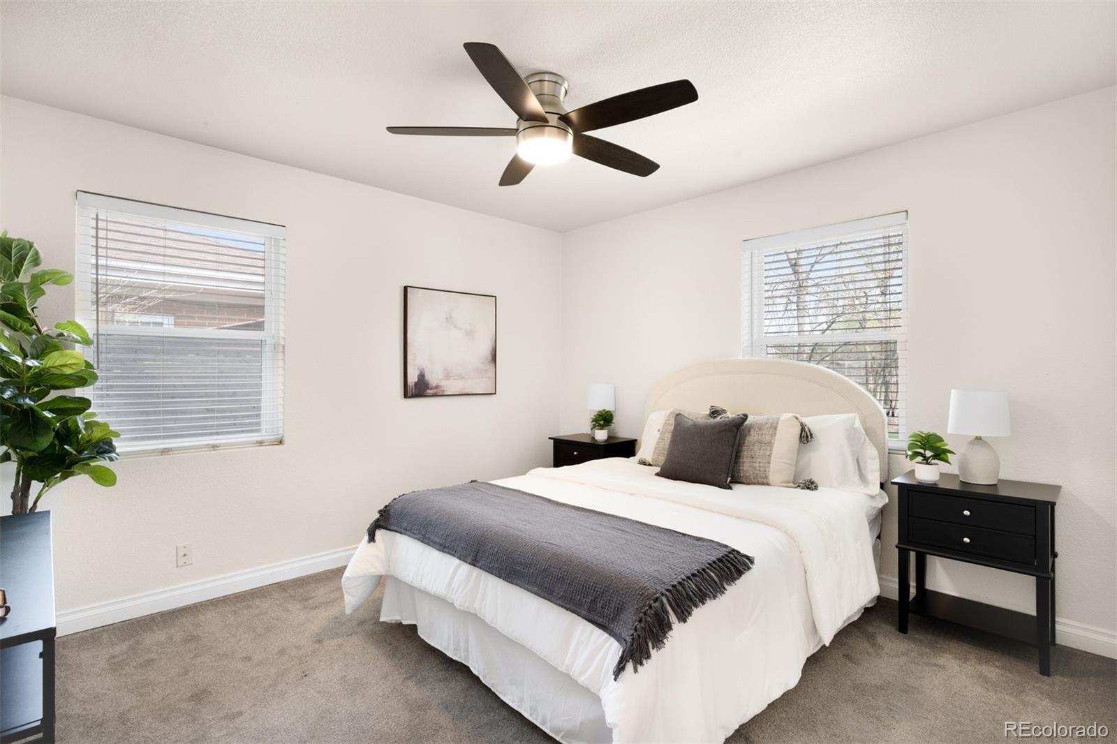 3000 Ivy Street Denver, CO 80207 - Photo 11 of 26 a bedroom with a bed and a potted plant