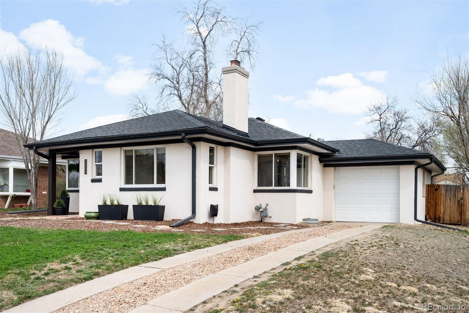 3000 Ivy Street Denver, CO 80207 - Photo 2 of 26 a front view of a house with a yard