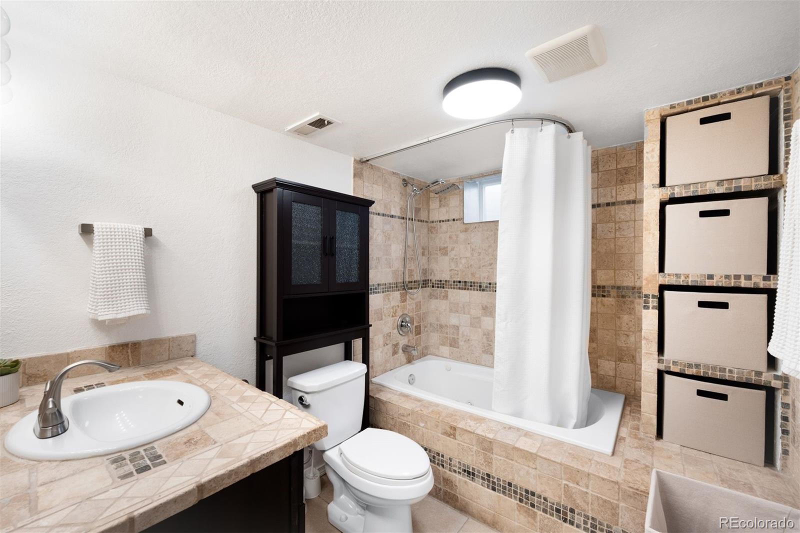 3000 Ivy Street Denver, CO 80207 - Photo 22 of 26 a bathroom with a sink toilet tub and shower