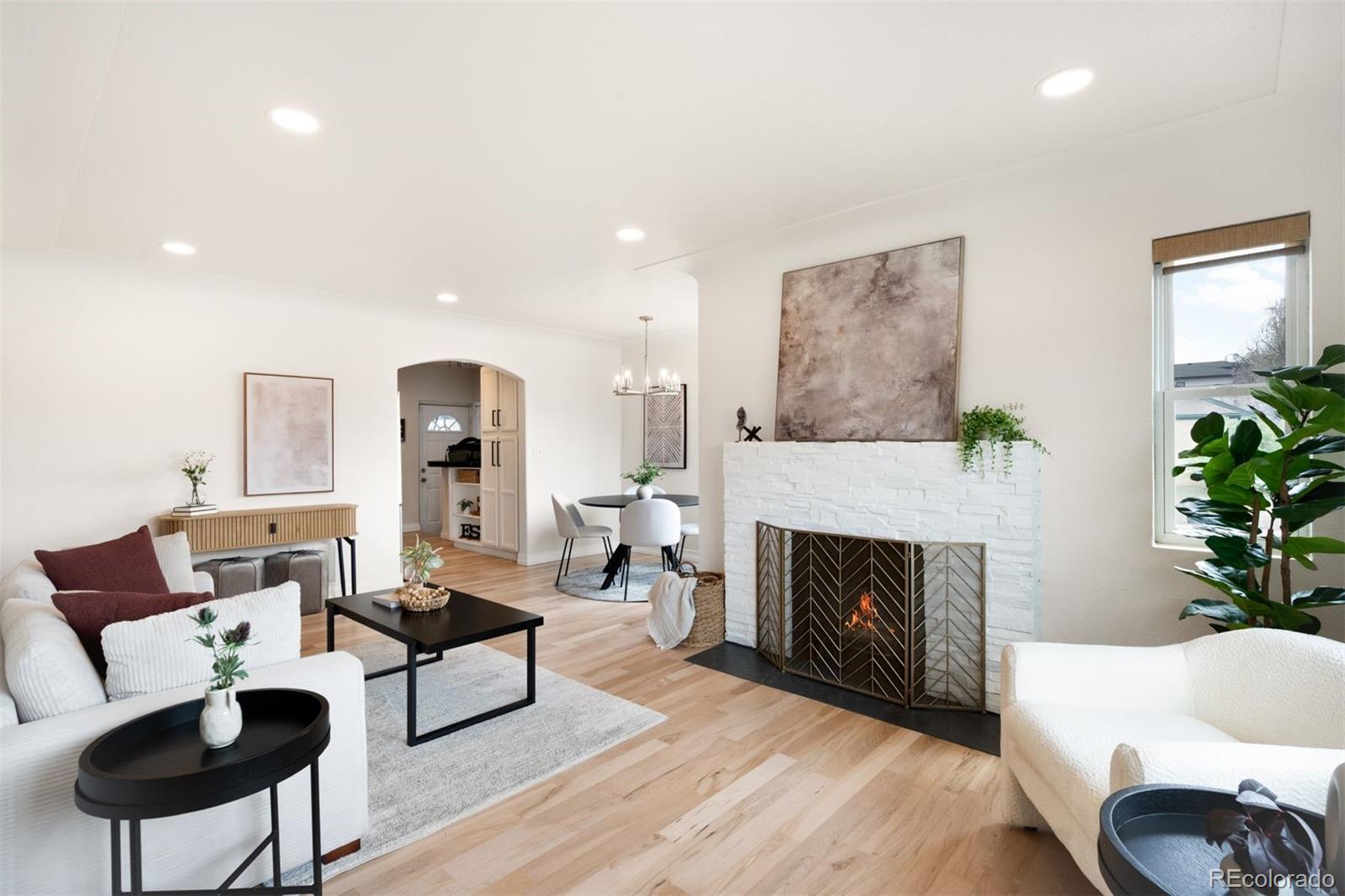 3000 Ivy Street Denver, CO 80207 - Photo 3 of 26 a living room with furniture and a fireplace