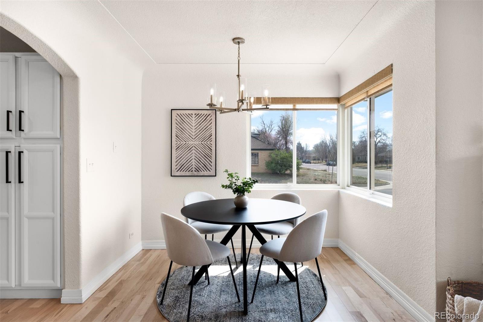 3000 Ivy Street Denver, CO 80207 - Photo 6 of 26 a dining room with furniture a chandelier and wooden floor