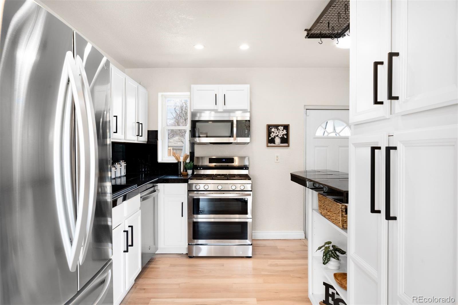 3000 Ivy Street Denver, CO 80207 - Photo 8 of 26 a kitchen with stainless steel appliances a refrigerator stove and microwave