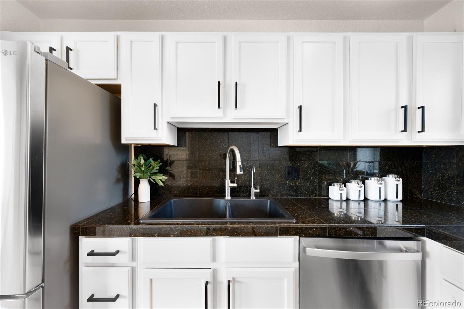 3000 Ivy Street Denver, CO 80207 - Photo 9 of 26 a kitchen with granite countertop a cabinets and a stove