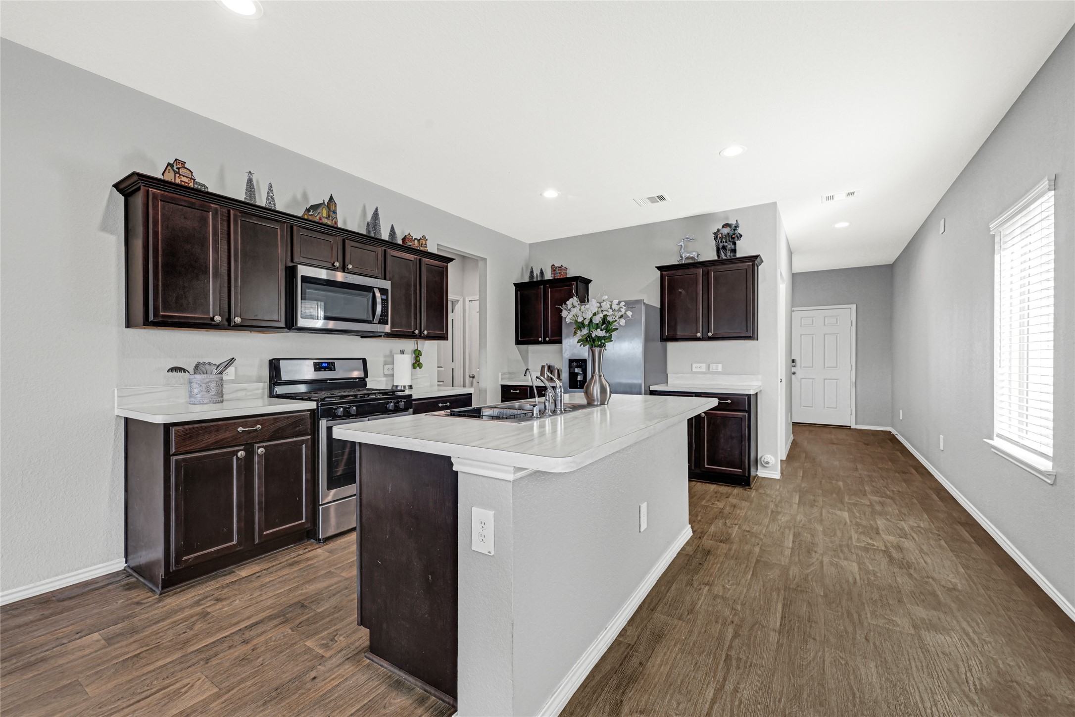 22707 Yarmony Vista Trail Spring, TX 77373 - Photo 2 of 26 a large white kitchen with stainless steel appliances stove microwave and cabinets