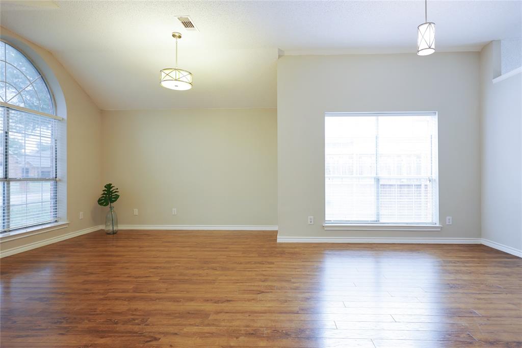 8112 Dock Street Frisco, TX 75035 - Photo 8 of 34 an empty room with wooden floor and windows