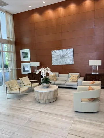 a living room with furniture and a lamp