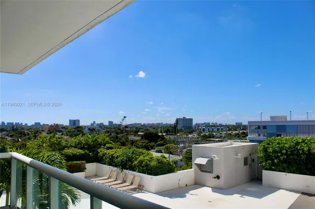 a view of a balcony with two chairs and a table