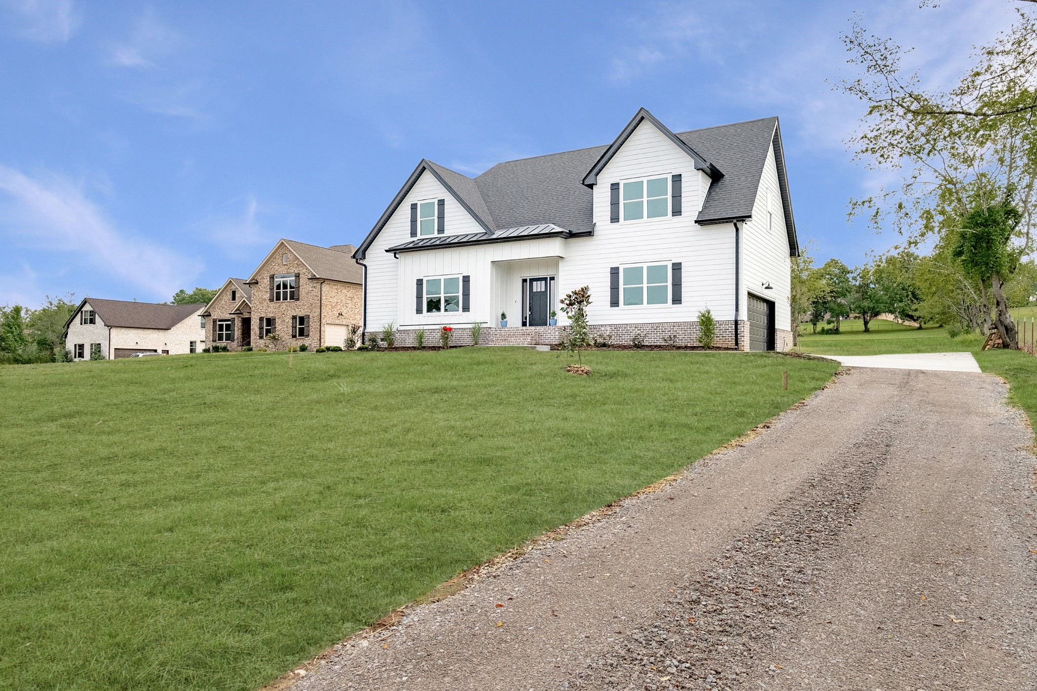 1227 Maple Hill Road Lebanon, TN 37087 - Photo 3 of 43 a front view of a house with a garden and yard