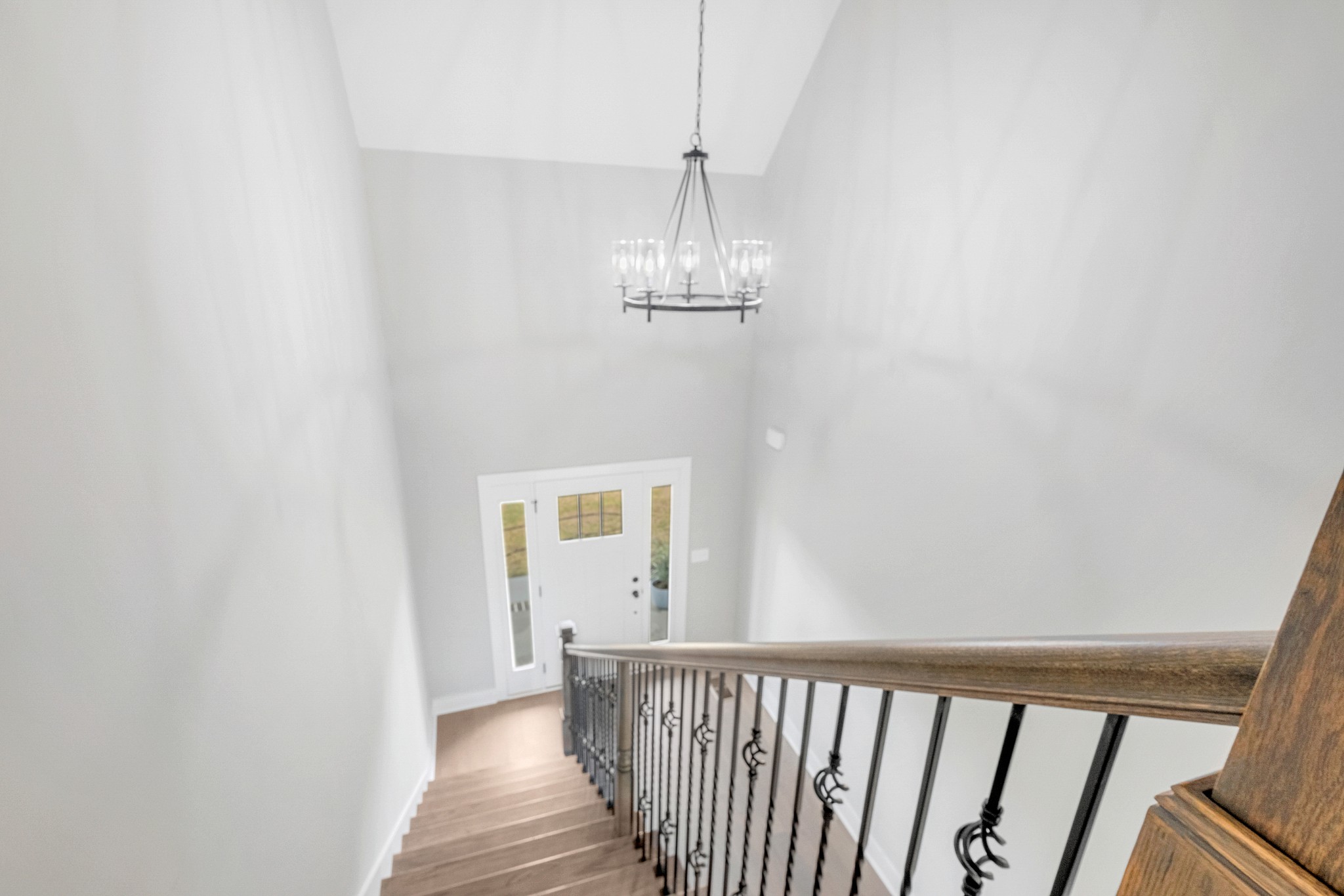 1227 Maple Hill Road Lebanon, TN 37087 - Photo 8 of 43 a view of a hallway with wooden floor and a chandelier