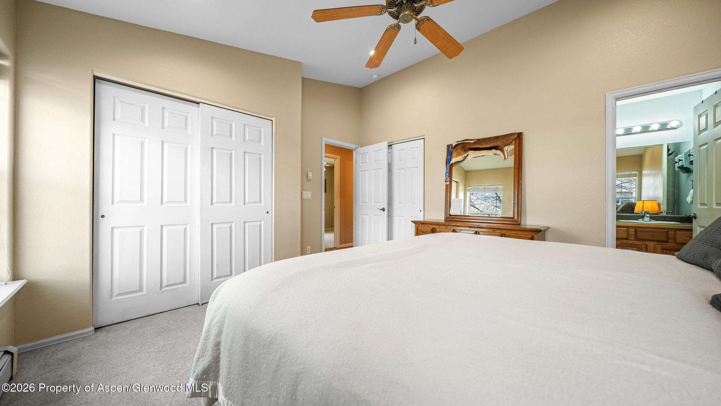 2703 Acacia Court Rifle, CO 81650 - Photo 14 of 29 a bedroom with a bed and large mirror