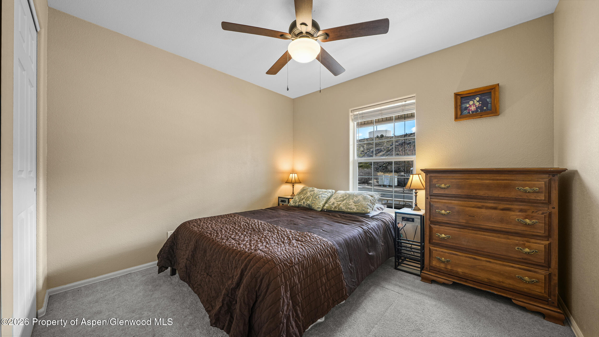 2703 Acacia Court Rifle, CO 81650 - Photo 16 of 29 a bedroom with a bed and a window