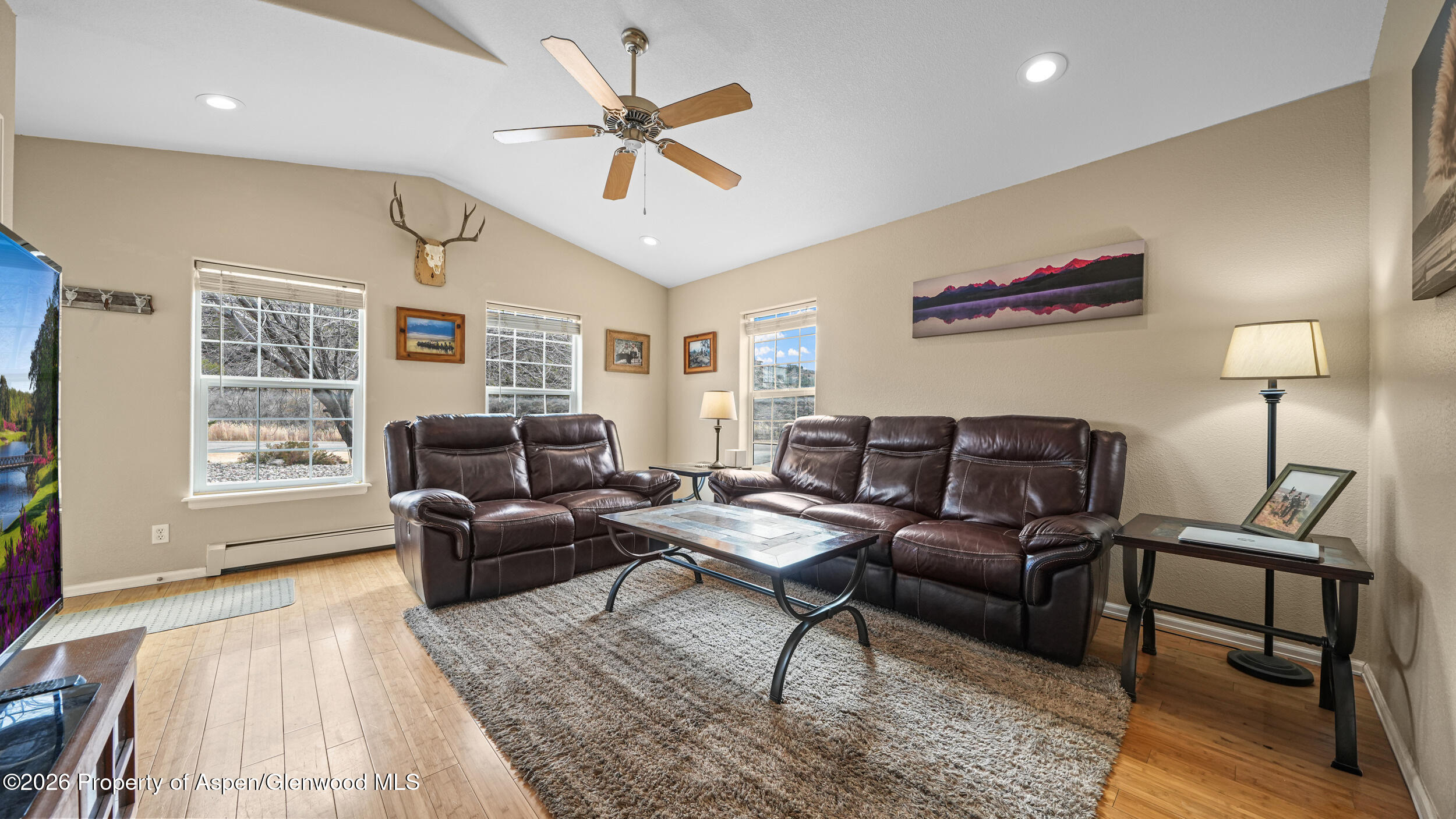 2703 Acacia Court Rifle, CO 81650 - Photo 4 of 29 a living room with furniture a ceiling fan and a rug