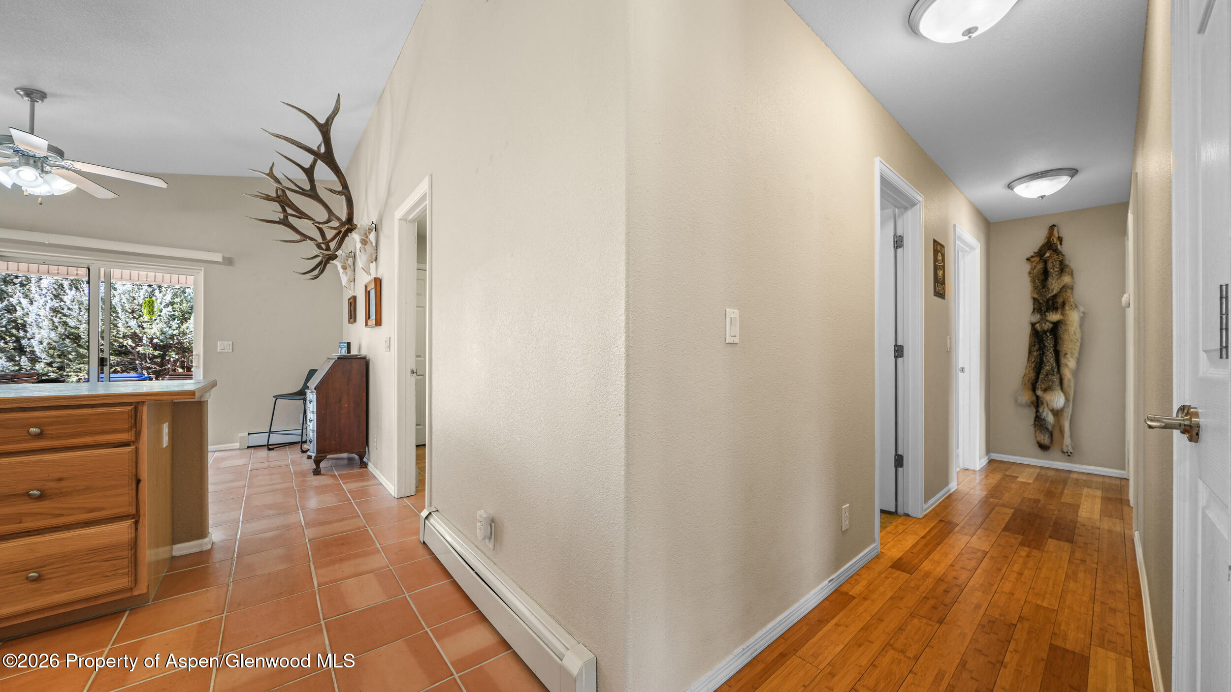 2703 Acacia Court Rifle, CO 81650 - Photo 7 of 29 a view of a hallway with wooden floor and a bathroom