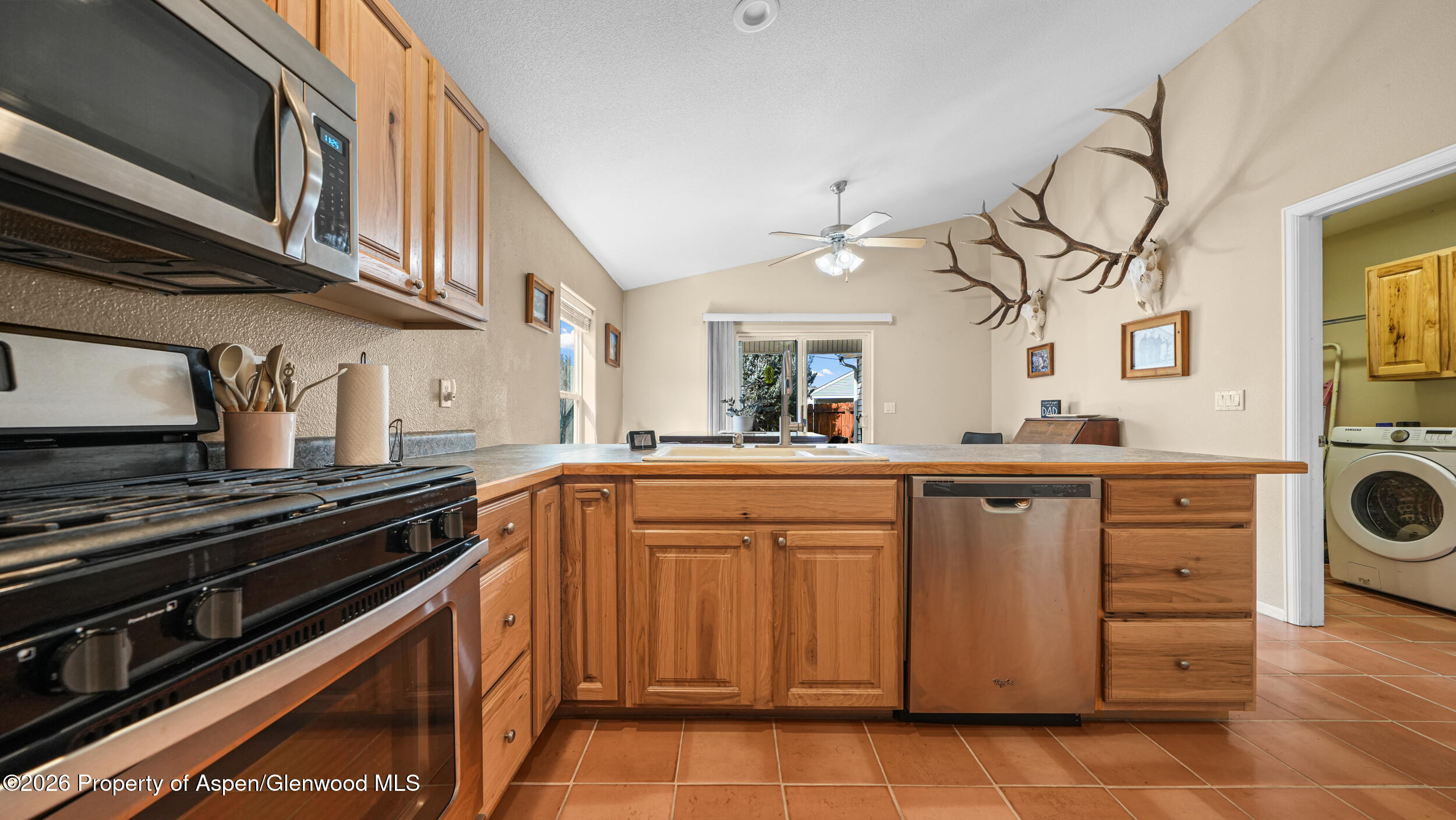 2703 Acacia Court Rifle, CO 81650 - Photo 9 of 29 a kitchen with a stove cabinets and a sink