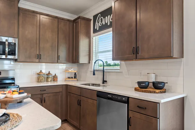 a kitchen with stainless steel appliances granite countertop a sink stove and cabinets