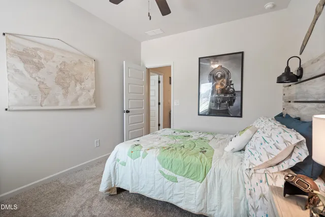 a bedroom with a bed and painting on the wall