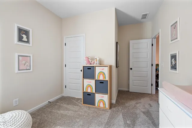 a view of a bedroom with a furniture and closet