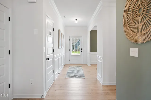 a view of a hallway with wooden floor and windows