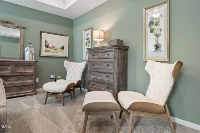 a living room with furniture and a chair