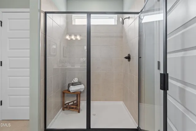 a bathroom with a glass shower door