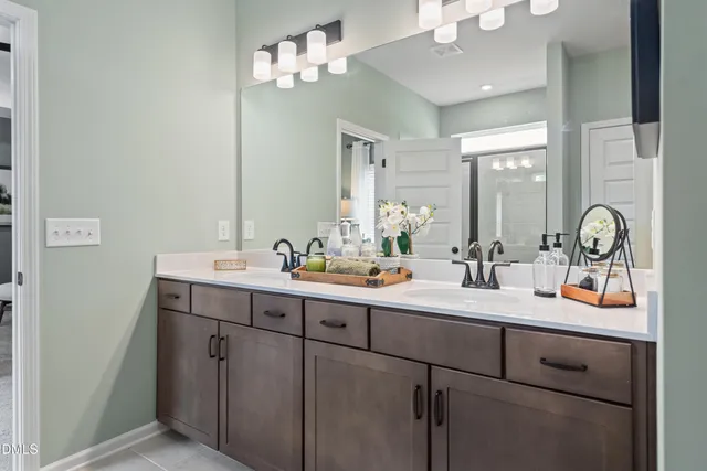 a bathroom with a double vanity sink and a mirror