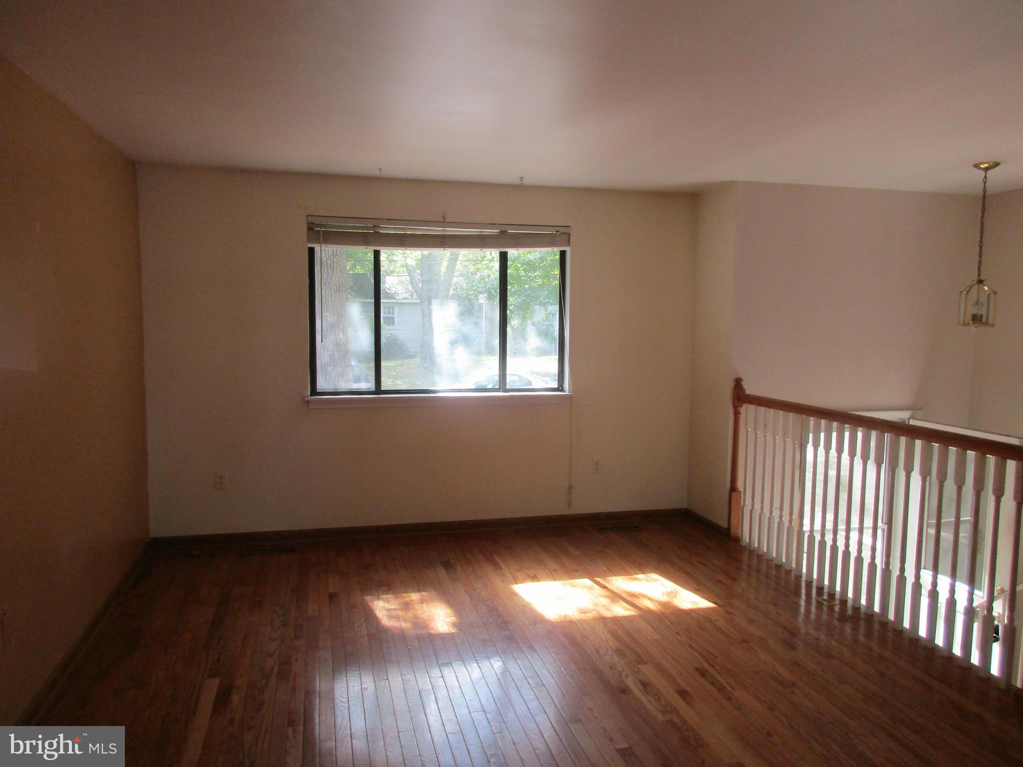 1635 Bay Ridge Road Edgewater, MD 21037 - Photo 2 of 15 an empty room with wooden floor and windows