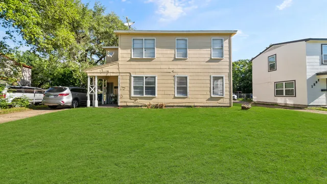 a front view of a house with a garden