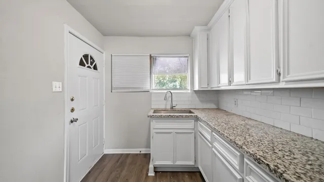 a kitchen with a sink stove and cabinets