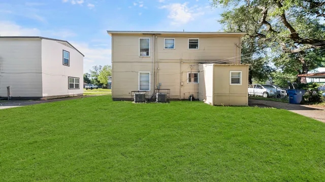a view of house with backyard