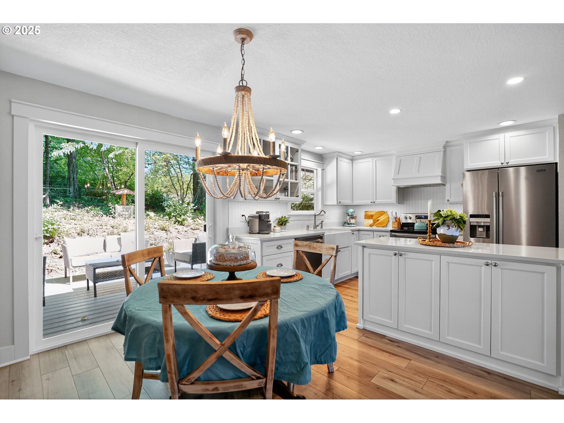 26280 South Beavercreek Road Beavercreek, OR 97004 - Photo 15 of 39 a kitchen with stainless steel appliances granite countertop a dining table chairs and white cabinets
