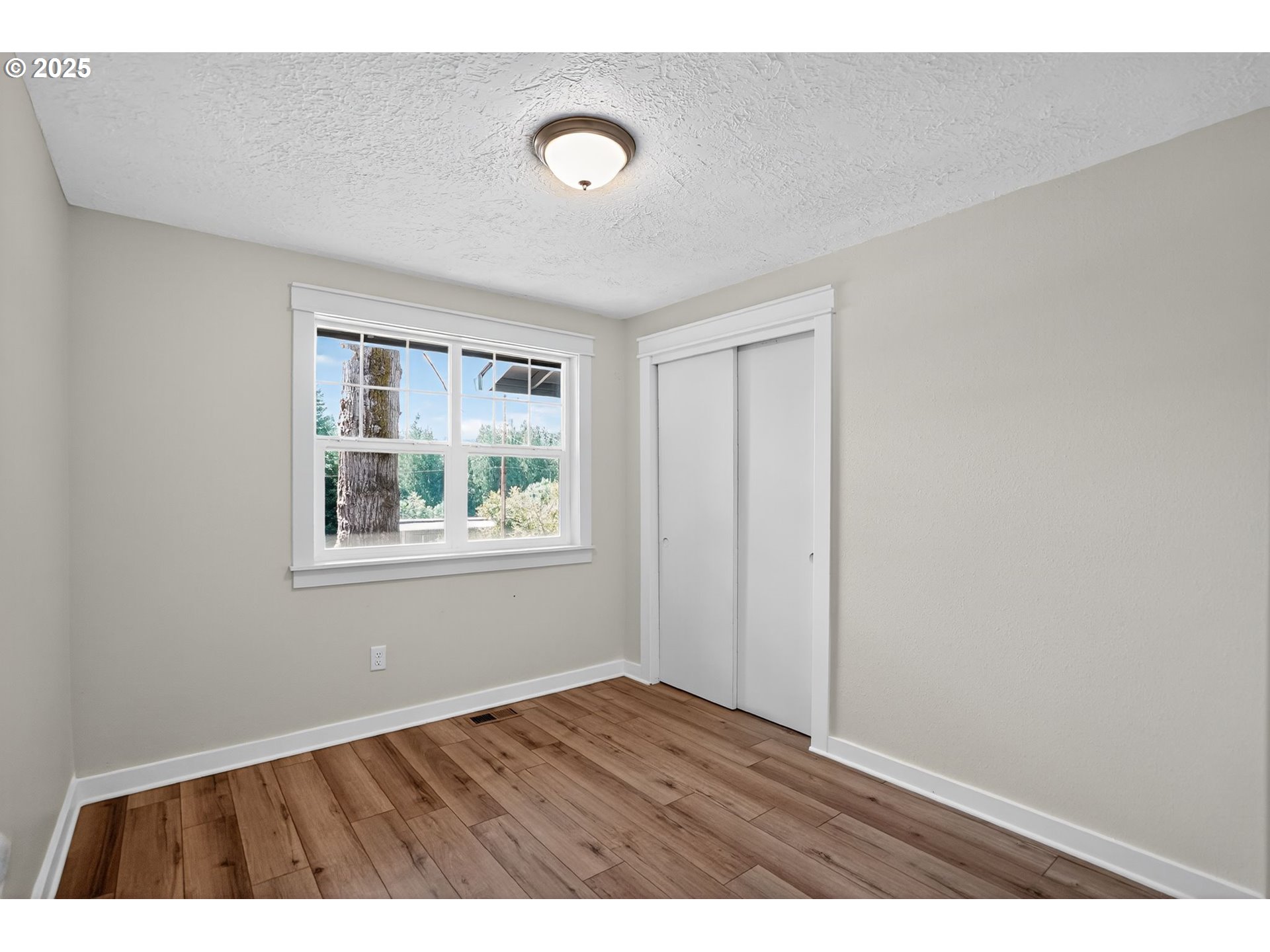 26280 South Beavercreek Road Beavercreek, OR 97004 - Photo 23 of 39 a view of an empty room with wooden floor and a window
