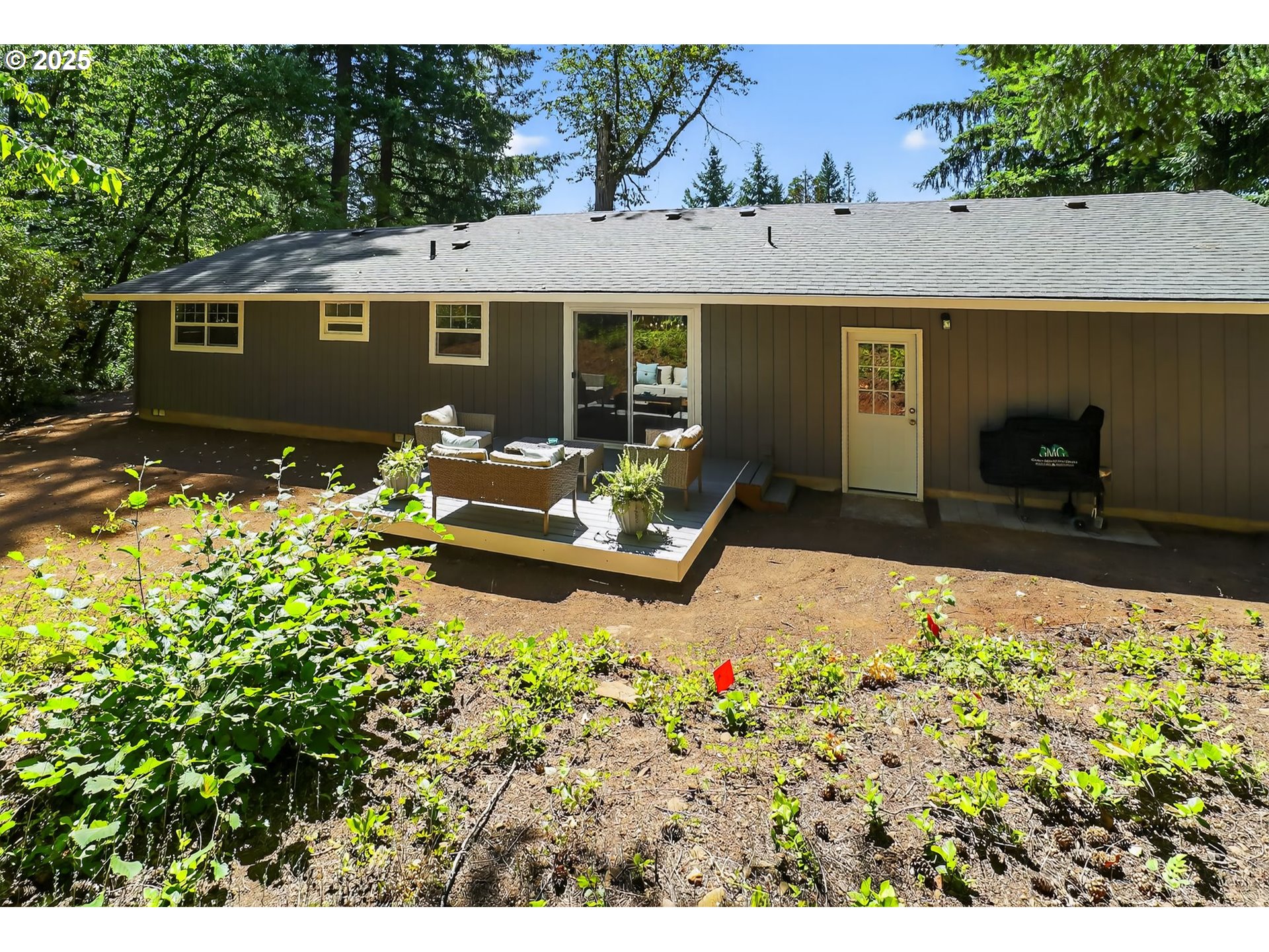 26280 South Beavercreek Road Beavercreek, OR 97004 - Photo 28 of 39 a front view of a house with a yard and a garden