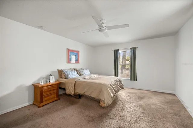 a spacious bedroom with a bed and a window