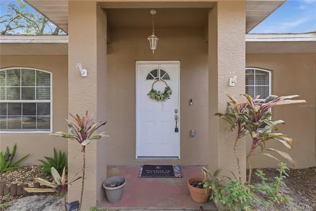 a vase of flowers sitting on a floor