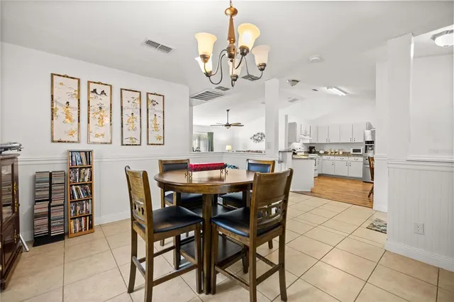 a view of a dining room with furniture and chandelier