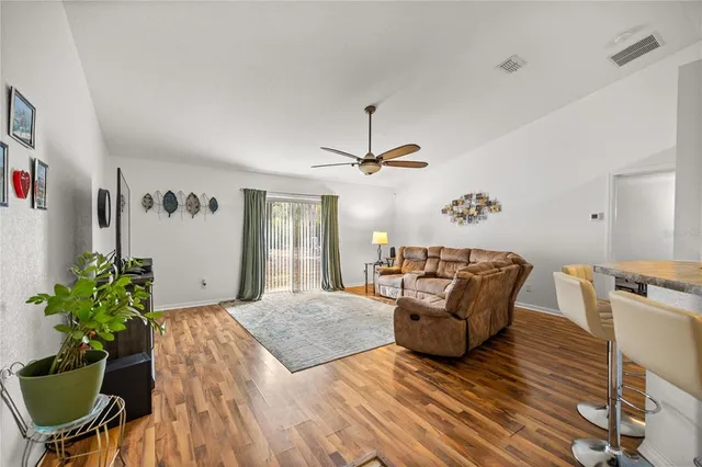 a living room with furniture and a potted plant