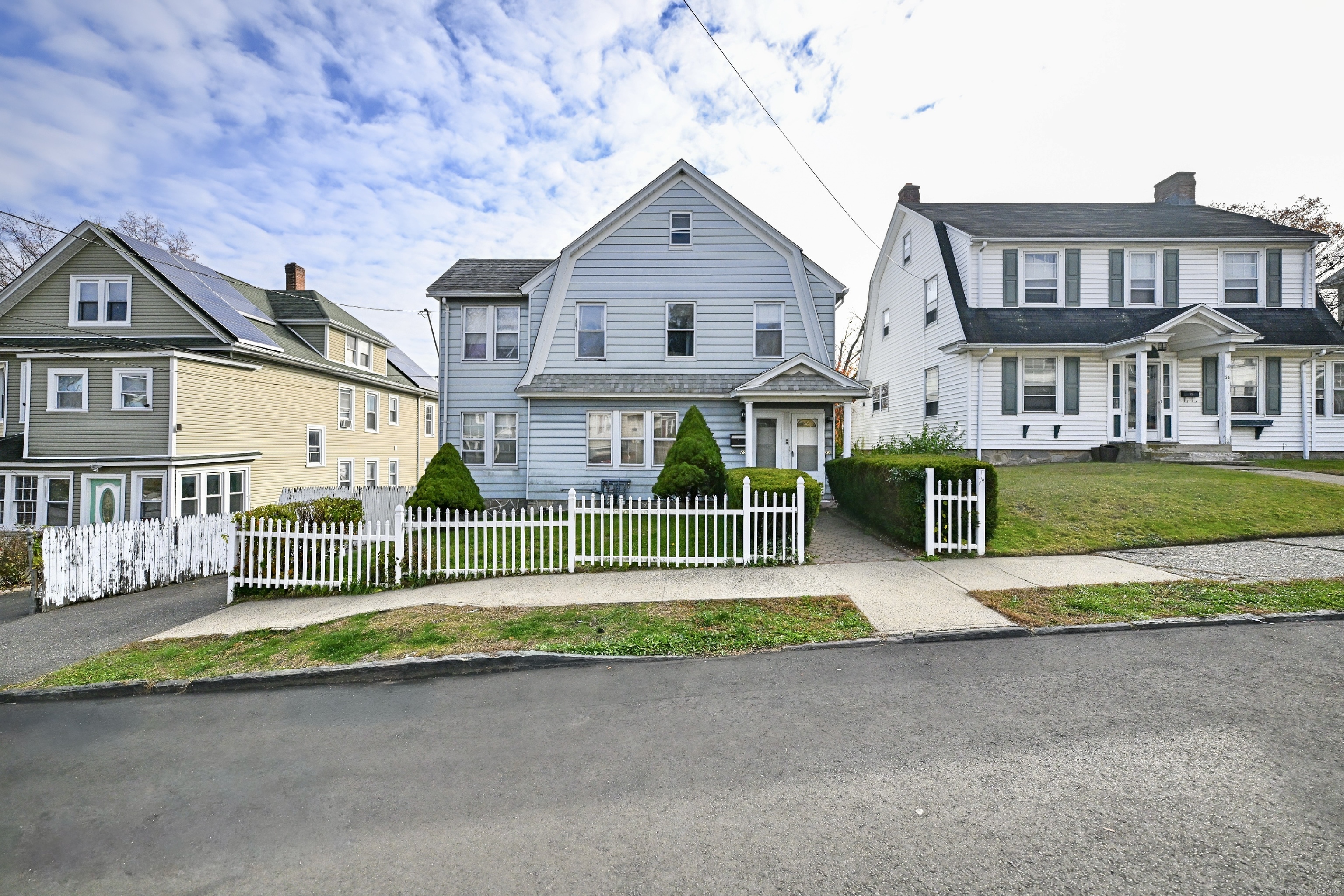 a front view of a house with a yard and table and chairs
