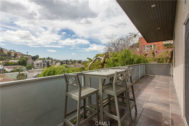 a view of a kitchen with a refrigerator and a stove top oven
