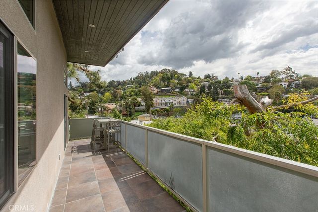 a view of a walk in closet and bedroom with furniture