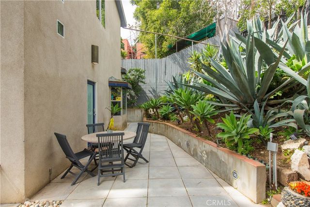 a view of a patio with table and chairs