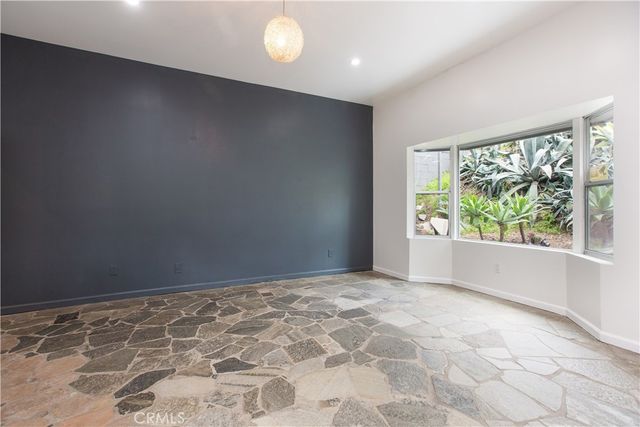 a view of a hallway with entryway and stairs