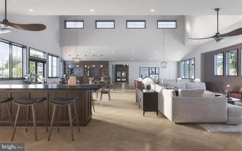 a living room with lots of furniture and view kitchen