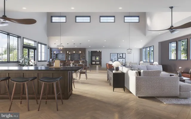 a living room with lots of furniture and view kitchen