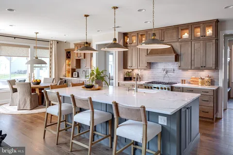 a kitchen with a table chairs stove and cabinets