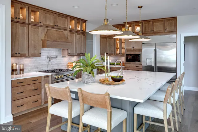 a kitchen with a table chairs stove and refrigerator