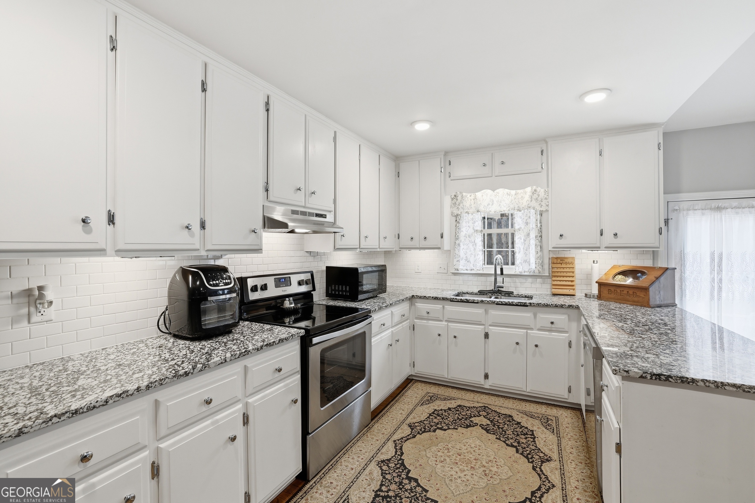 23 Cane Brake Circle Toccoa, GA 30577 - Photo 18 of 35 a kitchen with granite countertop a sink a stove and cabinets