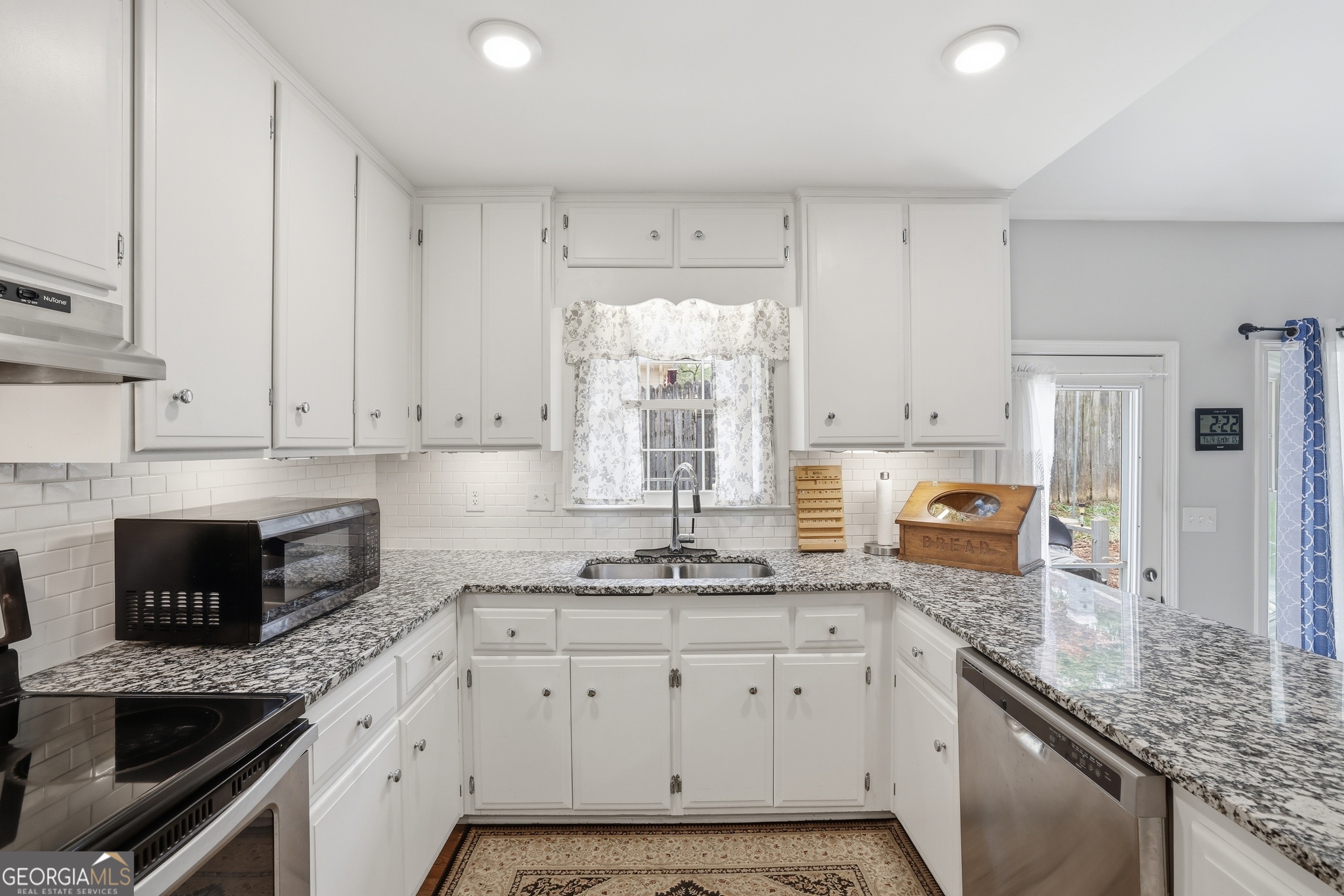 23 Cane Brake Circle Toccoa, GA 30577 - Photo 20 of 35 a kitchen with granite countertop white cabinets white appliances a sink and a window