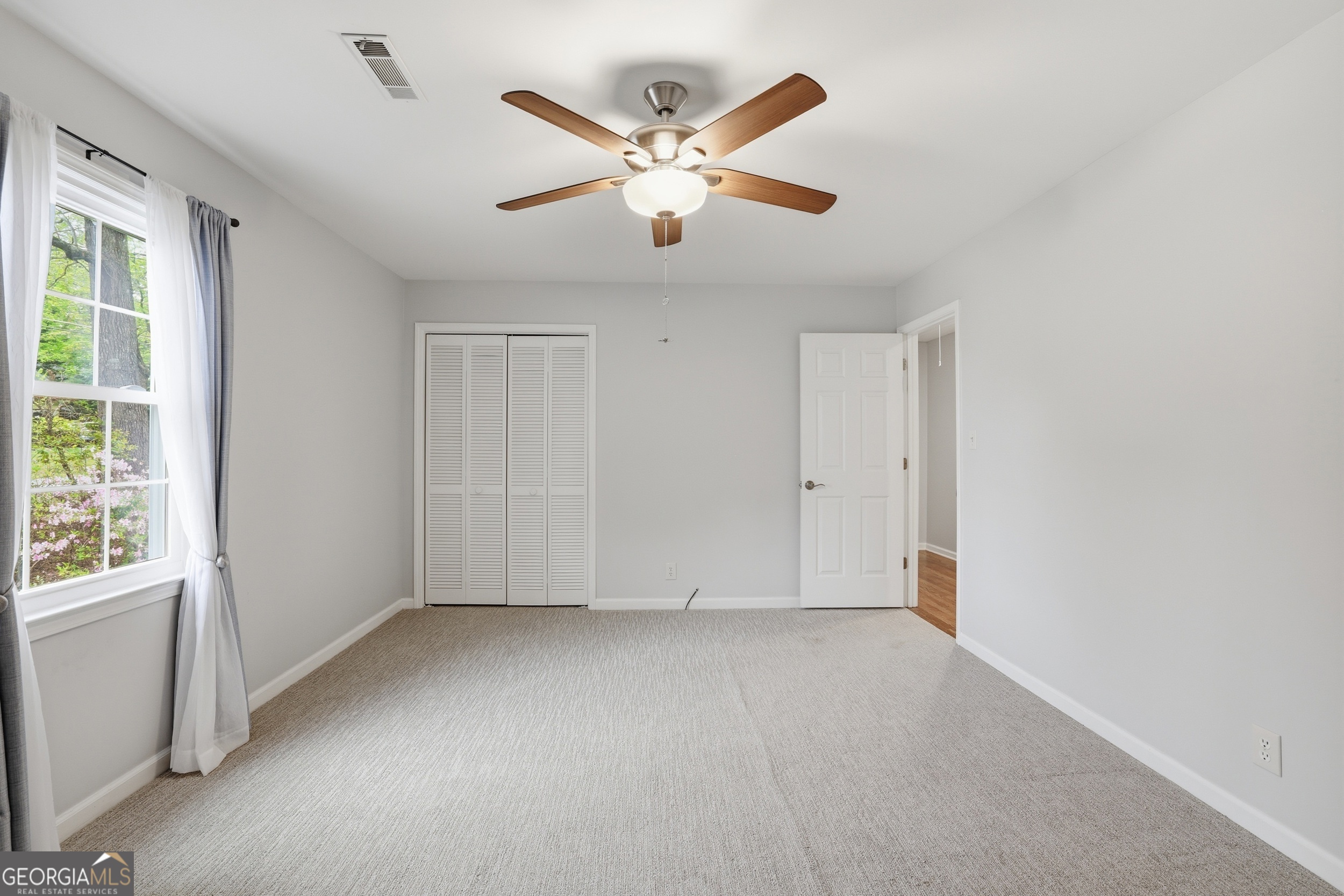 23 Cane Brake Circle Toccoa, GA 30577 - Photo 22 of 35 an empty room with ceiling fan and windows