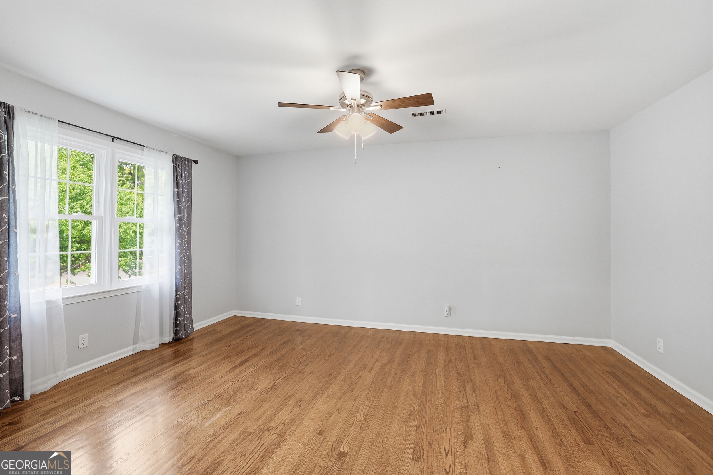 23 Cane Brake Circle Toccoa, GA 30577 - Photo 10 of 35 an empty room with wooden floor fan and windows