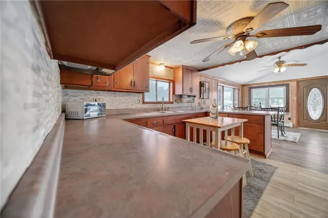 a kitchen with stainless steel appliances granite countertop a sink and cabinets